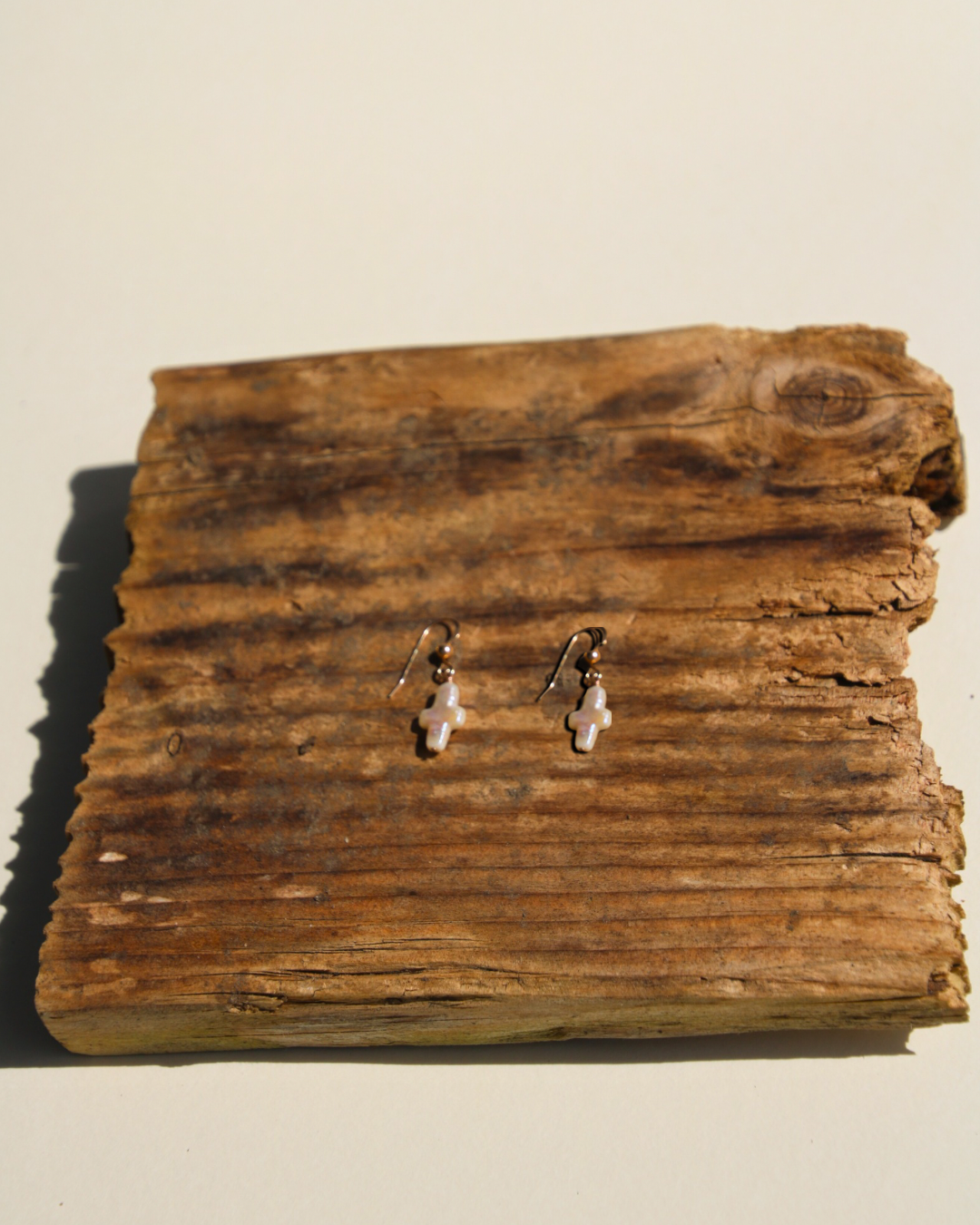 Pair of earrings on a wooden surface